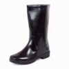 A Single boot of Dreamer safety gumboot. The shiny, black rubber safetygumboot rain boots with a simple design. The boots have a sturdy and flat sole with a modest tread pattern for grip. They reach mid-calf in height and are positioned side by side, with slight reflections visible on their surface.