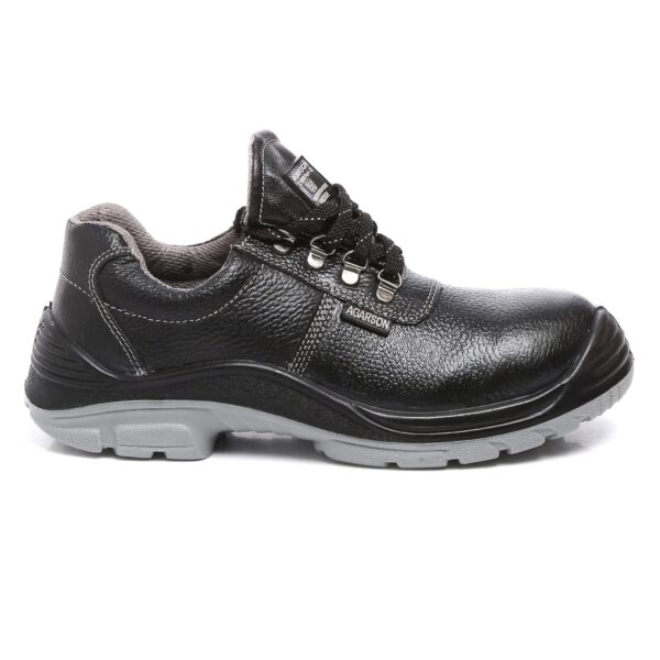 A single piece of black Duster Safety Shoe, rugged work shoes with a sturdy design and grey soles. These Agarsonshoes feature a reinforced toe, padded collars, metal eyelets, and lace-up closures, providing both comfort and durability. Brand tags are visible on the tongue and side, embodying reliable safetyshoes excellence.