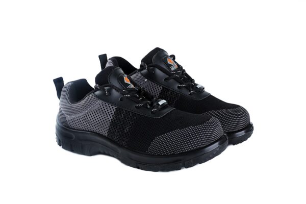 A pair of black and dark grey Agarson hyryder safety shoe with mesh detailing. The shoes have thick, black rubber soles, lace-up closures, pull tabs on the heels, and a small logo visible on the tongues featuring an orange and black design. These safety shoes are positioned side by side.