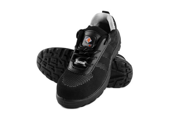 A pair of black athletic Nexon Safety Footwear from Agarson Safety Shoe with a knit mesh upper and synthetic overlays, featuring a lace-up design and a cushioned sole with a rugged tread pattern. The interior has a gray fabric lining, and there are small reflective details near the heel and sides.