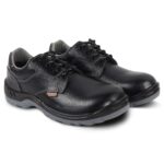 A pair of black leather Agarson safety shoes with a textured finish and lace-up design. The shoes have reinforced toe caps and sturdy, non-slip grey soles, providing durable protection. The padded lining offers enhanced comfort for long hours of wear.