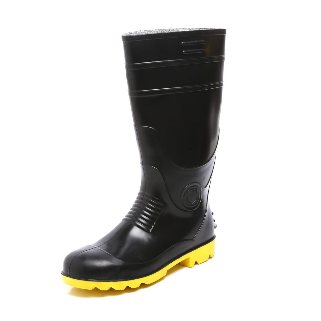 A pair of black rubber Safety Gumboot with yellow soles is shown on a white background. These best Safety gumboot are tall, featuring reinforced areas and rugged treads, making them ideal for heavy-duty work.