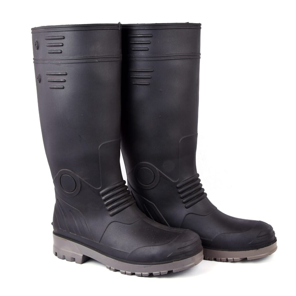 A pair of black rubber boot with gray soles, standing upright. Designed as the best work boot for manufacturers, these boots feature a high shaft and textured detailing near the top and heel, offering both style and protection.