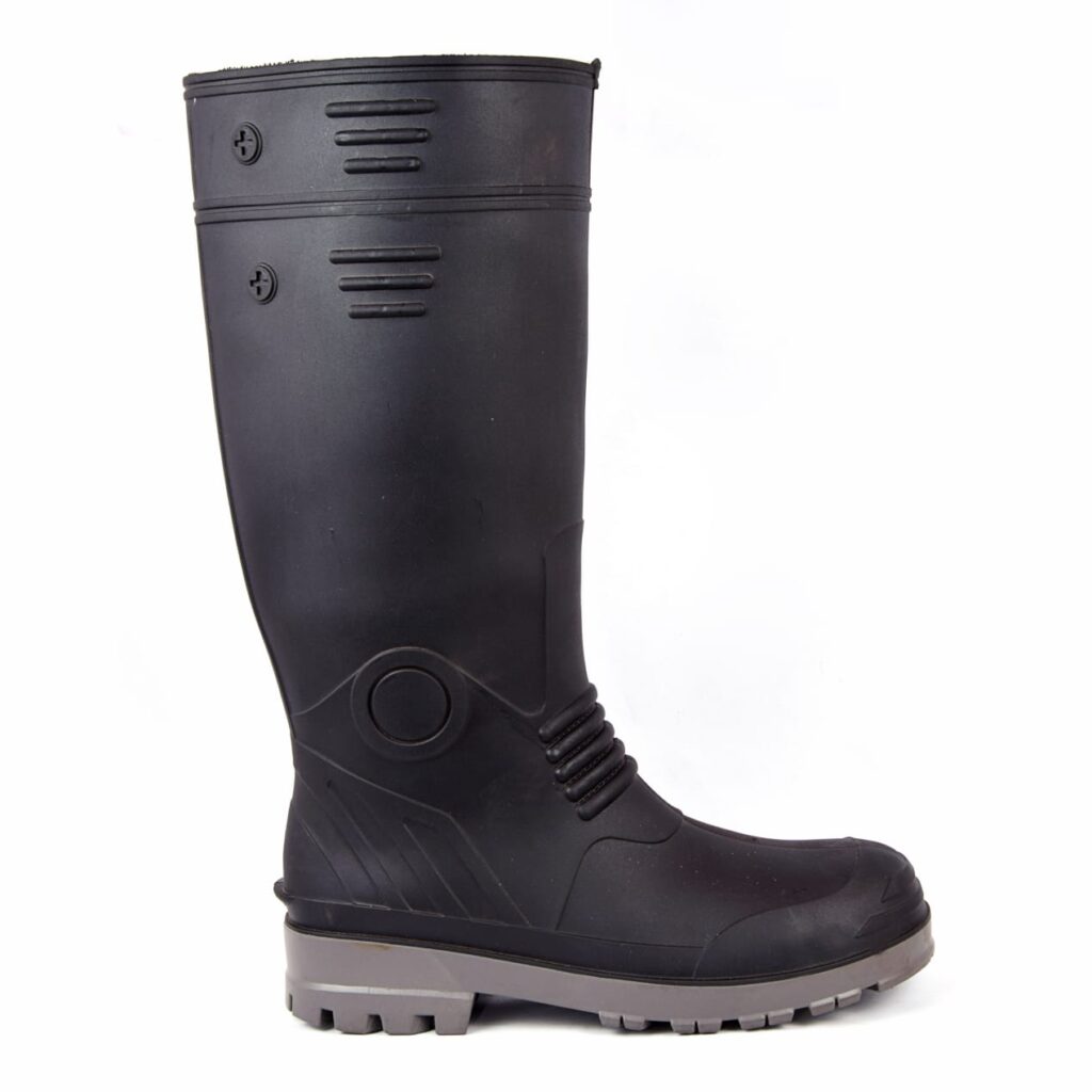 A black rubber Gumboot with gray soles, standing upright. Designed as the best safety gumboot for manufacturers, these Gumboots feature a high shaft and textured detailing near the top and heel, offering both style and protection.