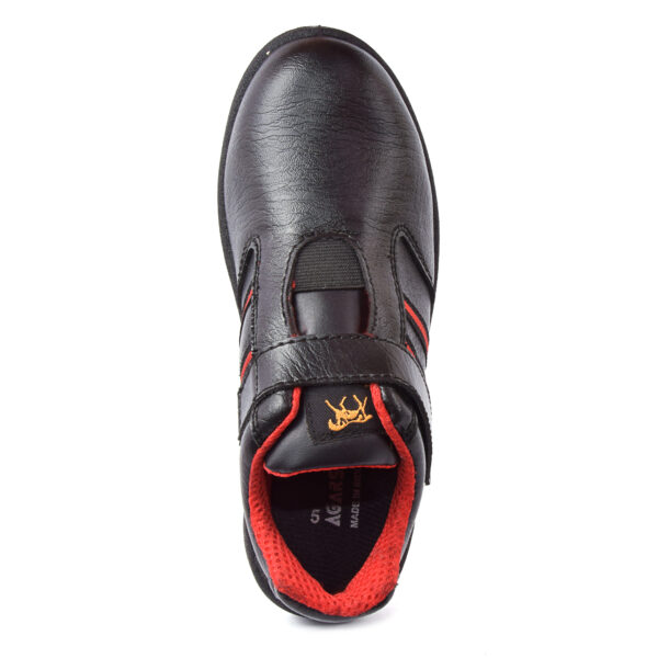 A single black upfront shoe with red accents, featuring sturdy soles and a hook-and-loop strap closure, perfect as safety shoes for women seeking both style and protection.